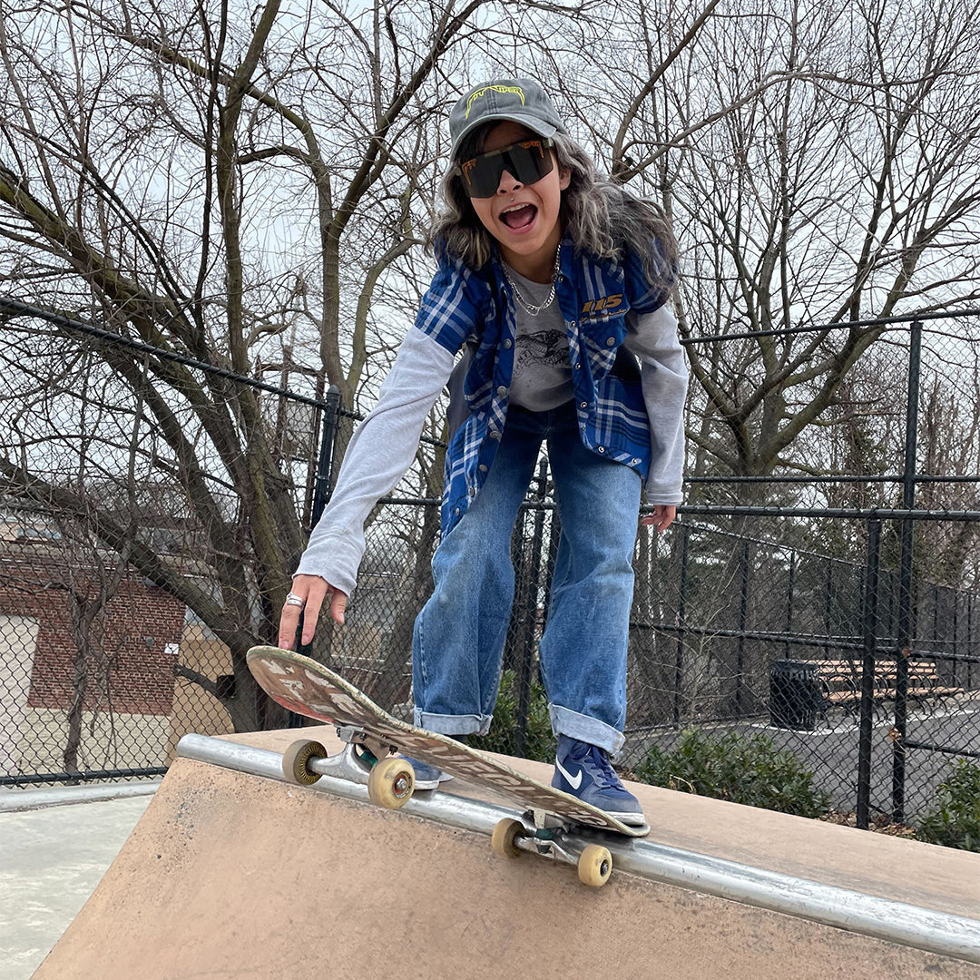 Narrow / Smoke | Woman skateboarding wearing The Big Buck Hunter Original from Pit Viper Sunglasses