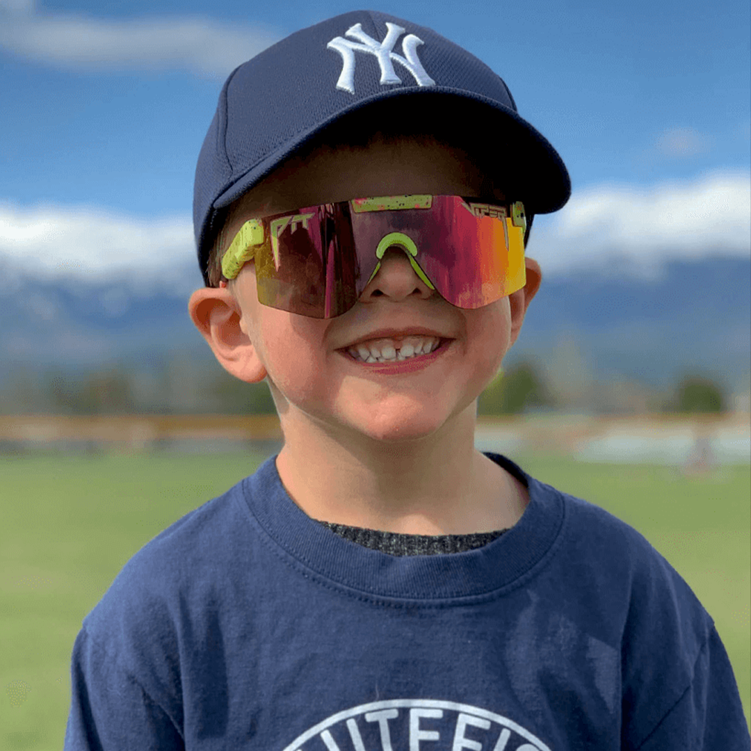 / Rainbow | Kid in a baseball hat wearing The 1993 XS from Pit Viper Sunglasses