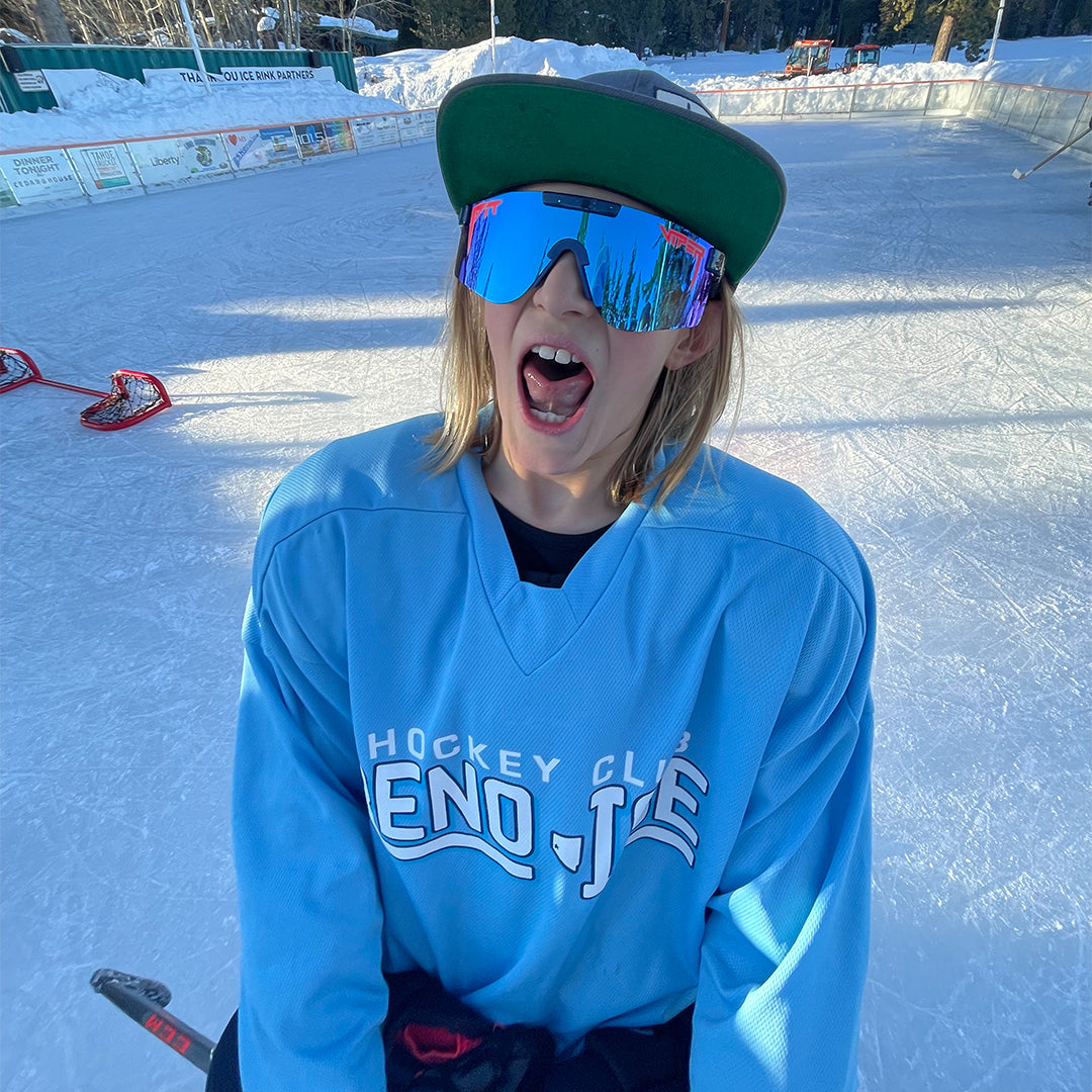 Wide / Polarized Blue | Kid on an ice rink posing in the The Basketball Team Original from Pit Viper Sunglasses