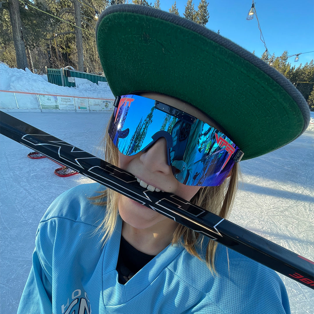 Wide / Polarized Blue | Kid with a hockey stick in his mouth wearing the The Basketball Team Original from Pit Viper Sunglasses