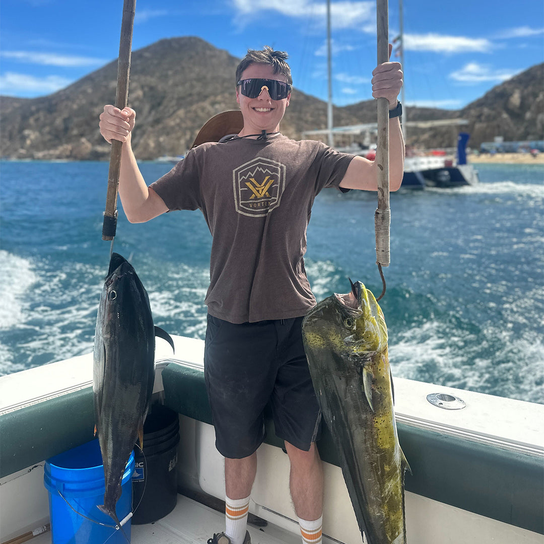 Wide / Polarized Smoke | Boy holding two big fish wearing The Naples Original from Pit Viper Sunglasses