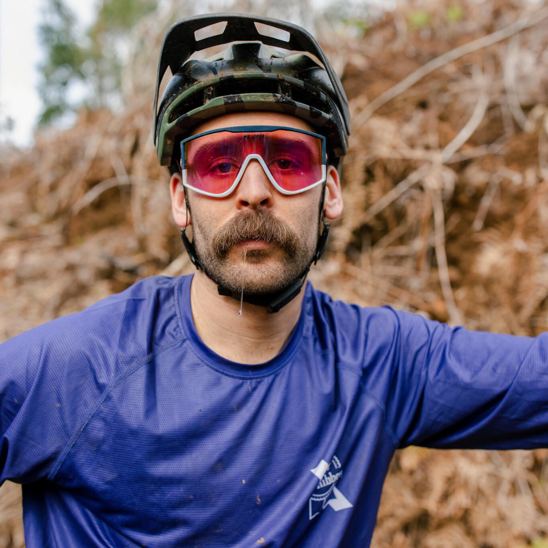 / Blue | Man drooling on a mountain bike wearing The Basketball Team Try-Hard from Pit Viper Sunglasses