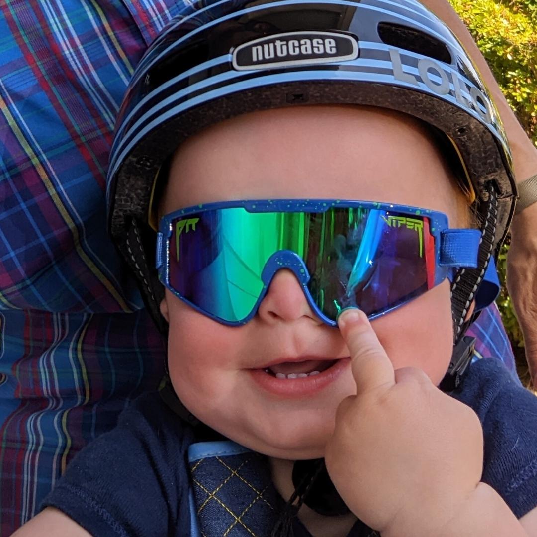 / Blue-Green | Baby wearing a helmet and The Leonardo Baby Vipes from Pit Viper Sunglasses