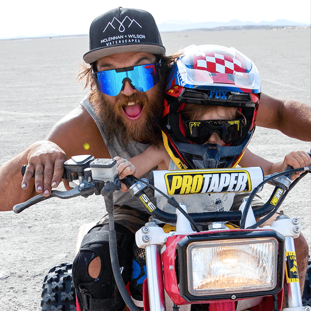 Wide / Polarized Blue | Man and kid on an ATV wearing The Peacekeeper Original from Pit Viper Sunglasses