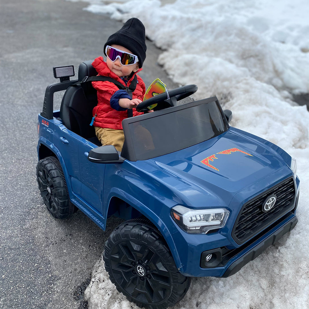 / Pink | Baby driving a kids car in The Miami Nights Baby Vipes from Pit Viper Sunglasses