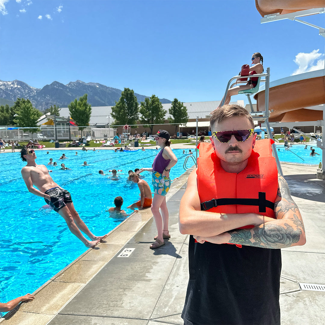 / Pink-Purple | Man wearing a life jacket and The Carnivore Showroom from Pit Viper Sunglasses