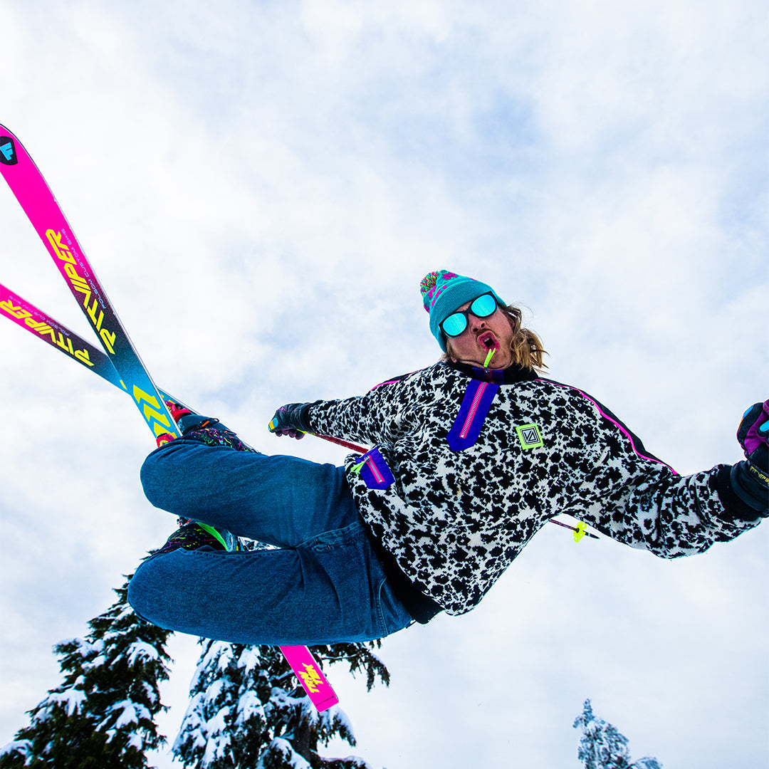 / Blue | Man jumping on skis wearing Pit Viper Sunglasses