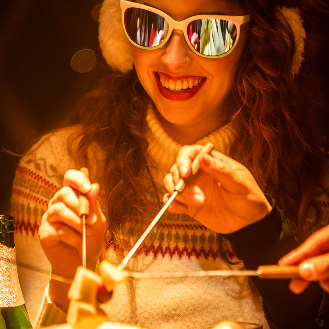 / Blue-Purple | Woman dipping bread in fondue wearing Pit Viper Sunglasses