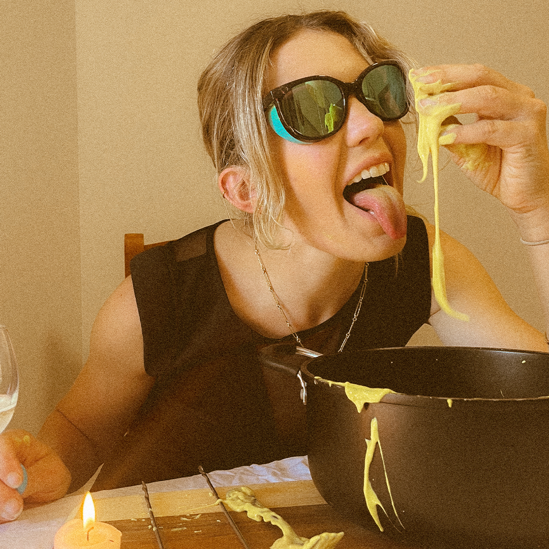 / Blue | Woman eating fondue wearing Pit Viper Sunglasses