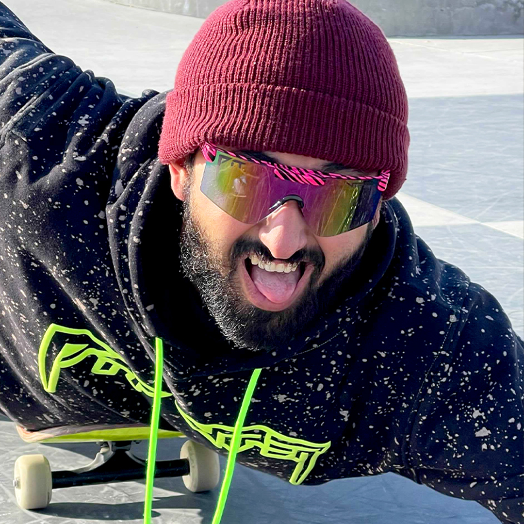 / Photochromic Rainbow | Man laying down on a skateboard wearing Pit Viper Sunglasses