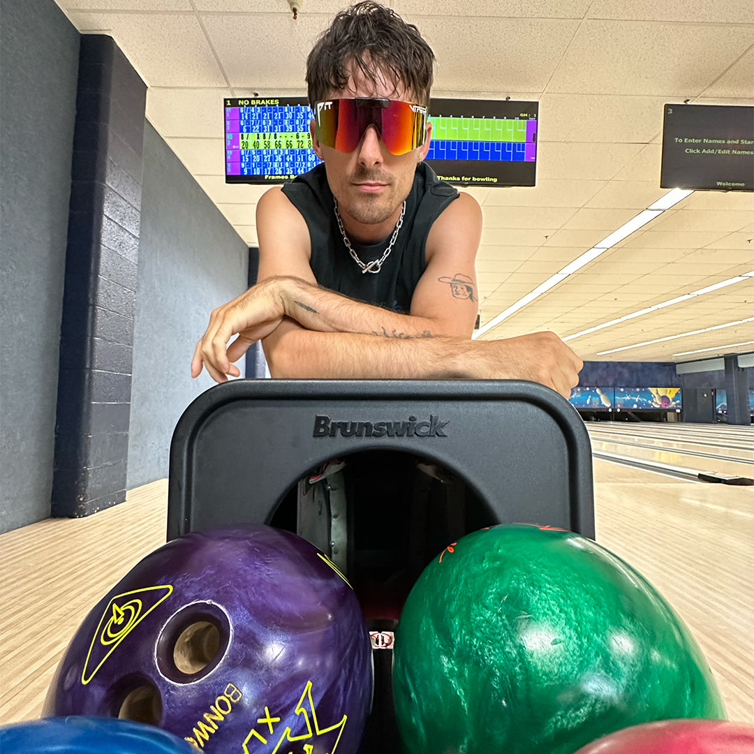 / Rainbow | A man at a bowling alley wearing Pit Viper Sunglasses