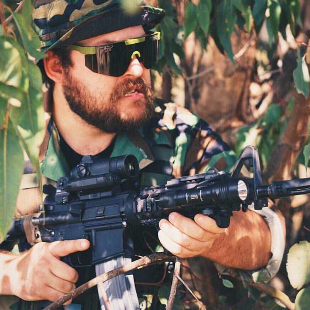 / BALL-ISTIC‚Ñ¢ Smoke | Man holding a gun wearing Pit Viper Sunglasses