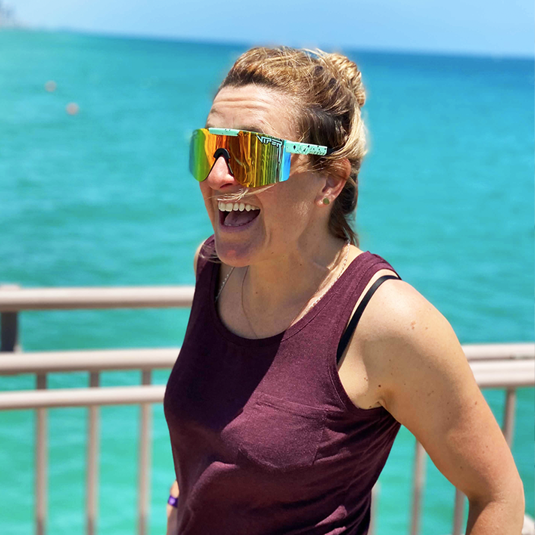 Wide / Polarized Rainbow | Woman smiling near the beach wearing The Poseidon Original from Pit Viper Sunglasses