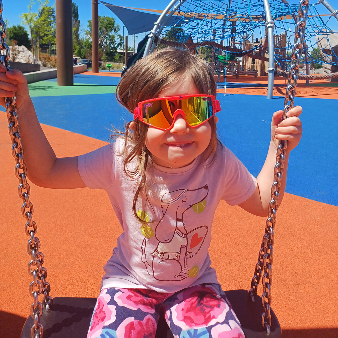 / Rainbow | Toddler on a swing wearing The Radical Baby Vipes from Pit Viper Sunglasses