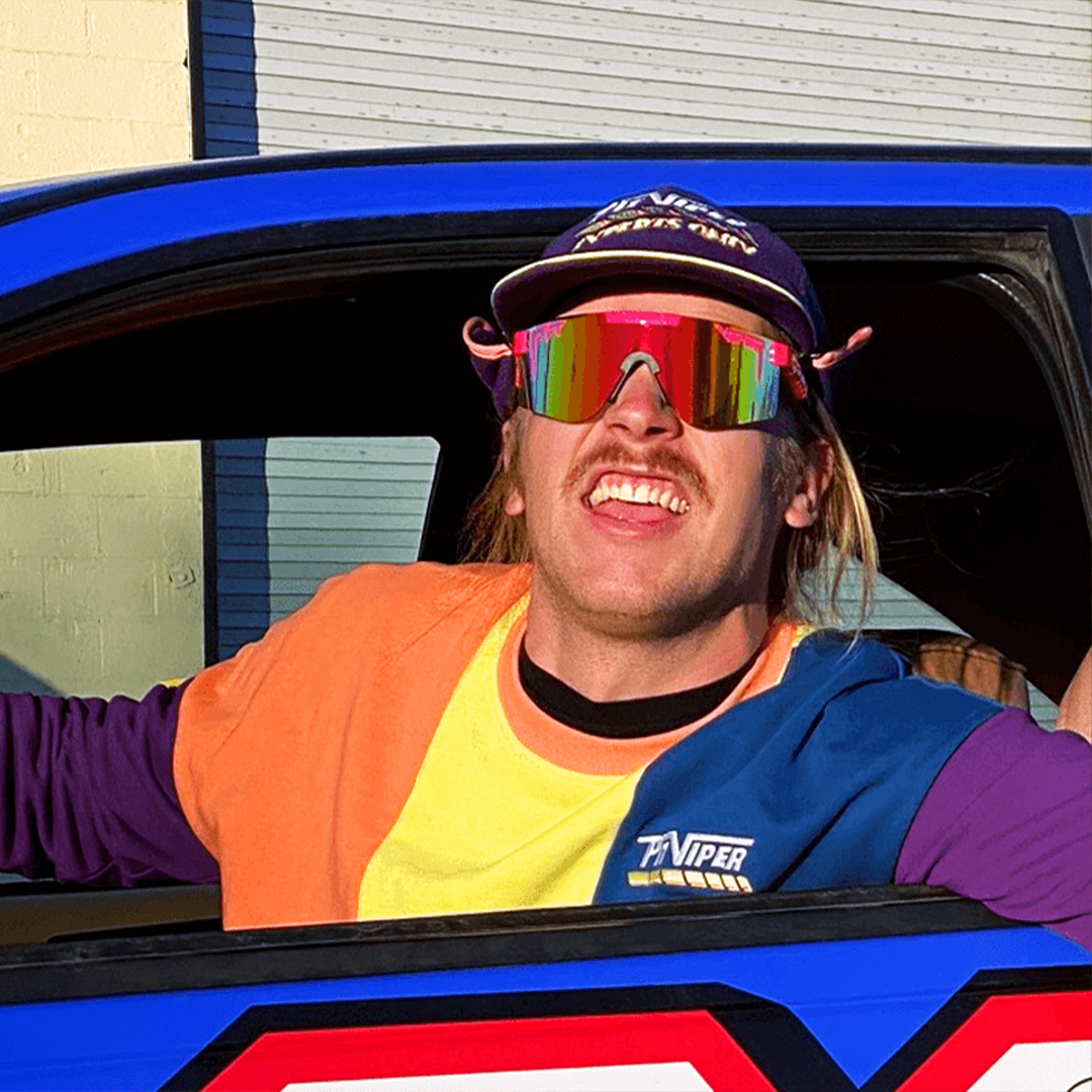 Wide / Polarized Rainbow | Man in a car wearing The Radical Original from Pit Viper Sunglasses